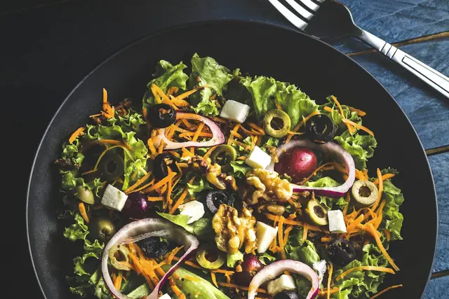 Colourful healthy salad bowl with greens, vegetables and seeds